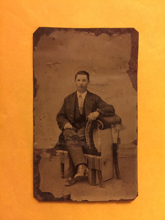 male-seated-in-upholstered-chair